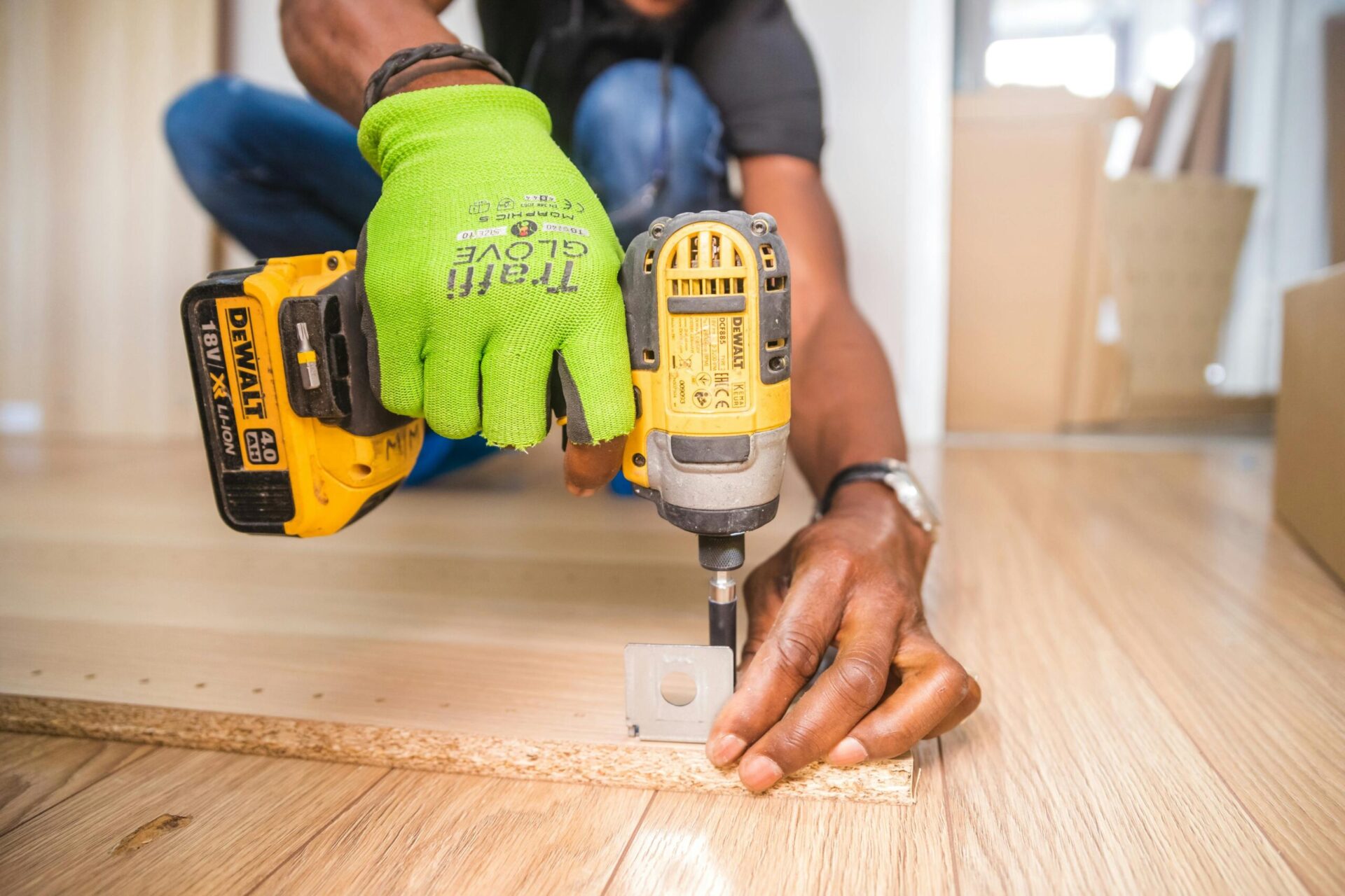 Man using a power drill for assembling furniture after a move